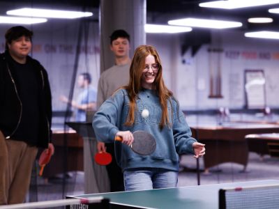girl hitting a ping pong ball
