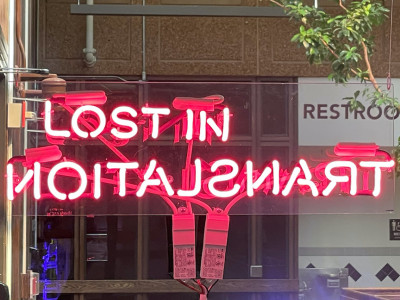 neon sign in hot pink reading 'lost in translation'
