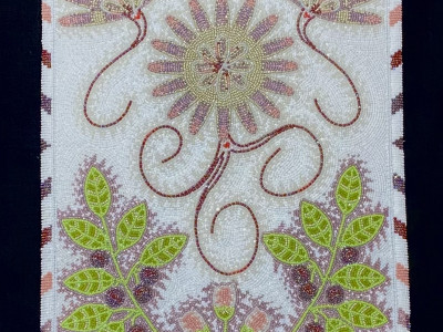 leatherwork purse with beadwork in the design of bitterroot flowers and huckleberries with leaves