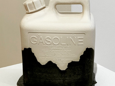 porcelain cast gasoline container, white with a black glaze "stain" covering the bottom half as if something has been spilled on it