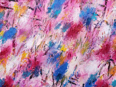 abstract painting with dabs of bright blue, pink, yellow, orange, white, and pale pink. illegible text is inscribed through the paint layer onto a charcoal layer below