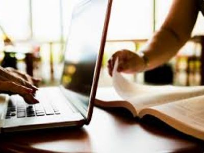 A laptop and book