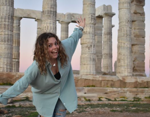 Girl standing in front of monument in Greece