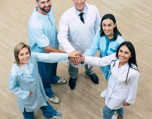 Top view full-length photo of happy successful medics team while conversation at the hospital