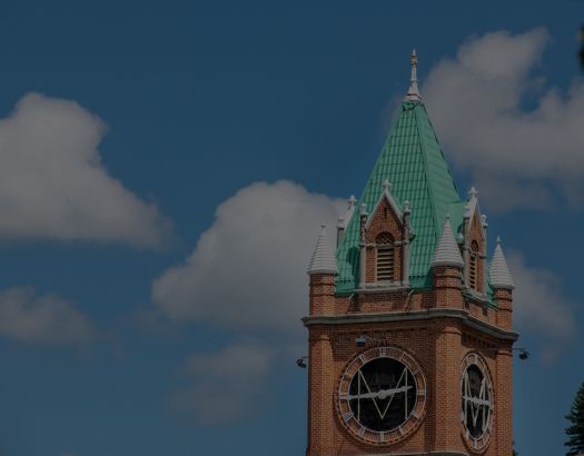 Main Hall steeple against blue sky and clouds