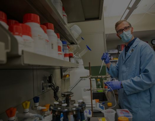 student works in lab with mask on