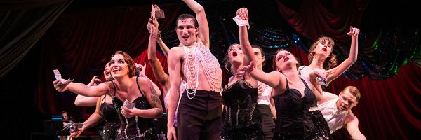 group of students in costume posing on stage