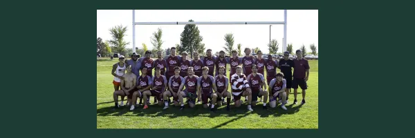 Members of UM's men's rugby club gather in two rows for a photo