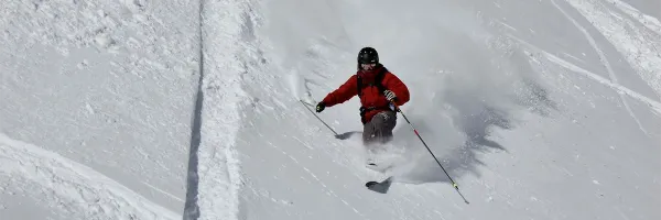 A telemark skier makes powder turns