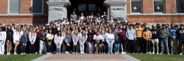 UM fraternity and sorority students pose for a photo in front of Main Hall