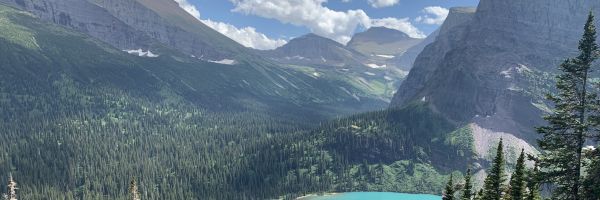 small, steep mountain valley seen from above with small lake below