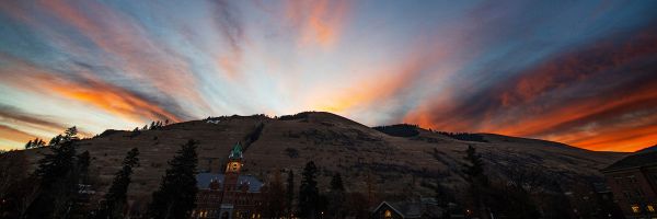 University Hall and the M trail with dramatic sunset from behind 