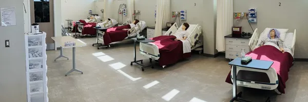 human mannequins laying in a row of five hospital beds in a Missoula College classroom
