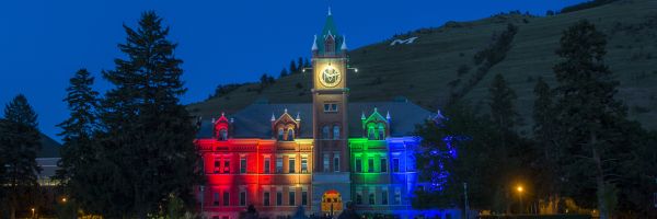 University Hall at night light up with various colors