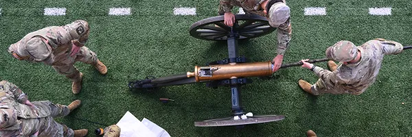 An aerial view of the UM ROTC Boom Crew members in uniform loading the cannon at a football game in Washington-Grizzly Stadium in Missoula, 51�Թ���.