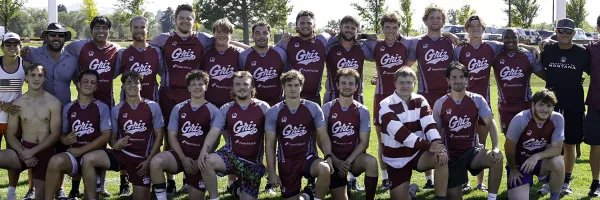 Members of UM's men's rugby club gather in two rows for a photo
