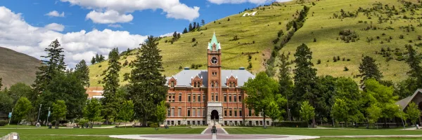 University Hall and the M trail on a sunny day from the Oval on the 51�Թ��� Campus in Missoula, MT.
