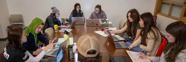UM students working together at Study Jam, using laptops and notebooks in a bright, collaborative space