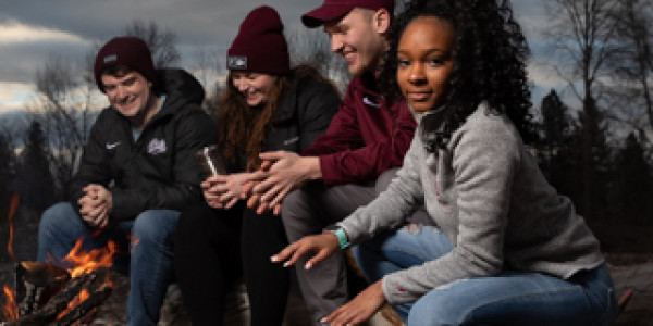 UM students by a fire