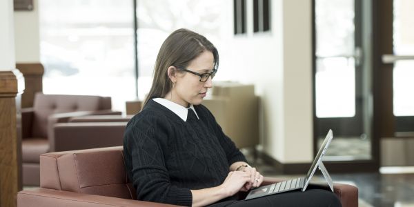 a woman studies with her laptop
