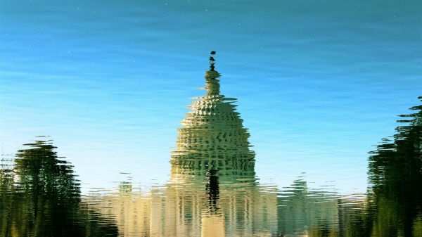 Picture of the capitol building reflected in water