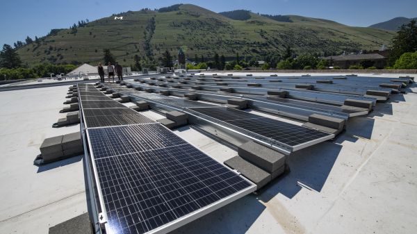 rooftop solar arrays glisten in sun on top of Eck Hall