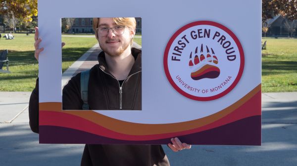 TRIO student poses with First Gen Proud cutout.