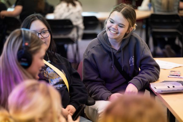 students sitting together talking and smiling