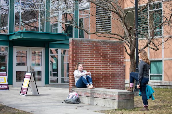 two students talking outside of the curry health center