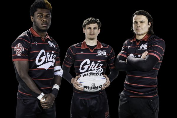 Three Rugby Players Around a Ball