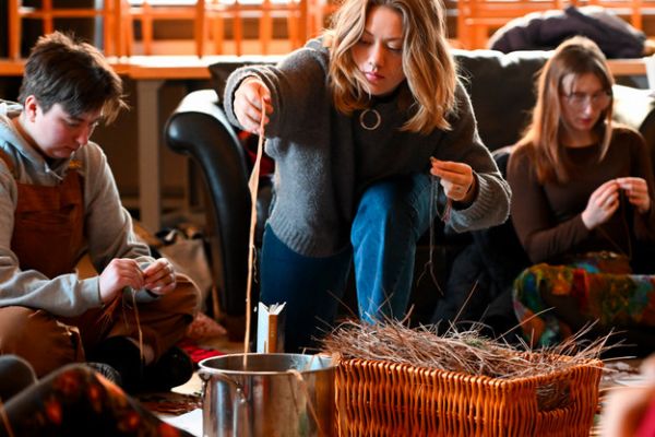 students participating in a candle making activity