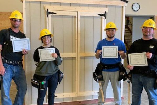 group of employees who completed their training in a form of construction work holding their certificates