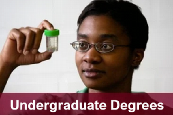 Woman holding a test tube at eye level