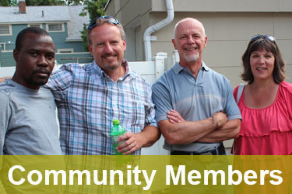 Group of men and women standing in a yard