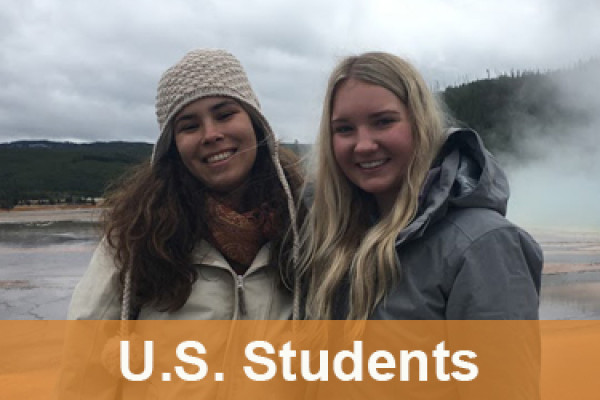 Two girls standing and smiling for a photo