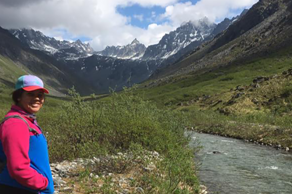 Brianna Ashley posing in a mountain valley