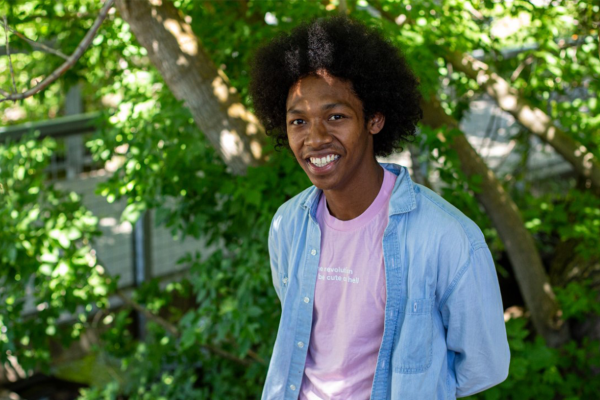 Elijah Jalil Paz Fisher posing in front of some trees and bushes