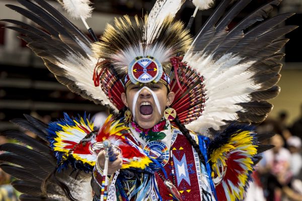 Indigenous student performing in a powwow