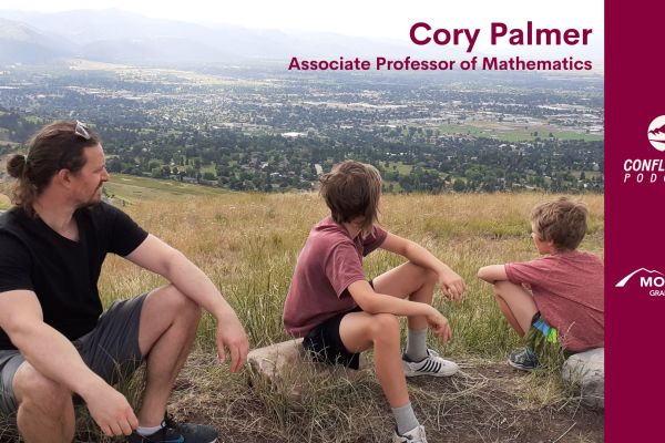 Cory Palmer and two kids on a hill overlooking Missoula