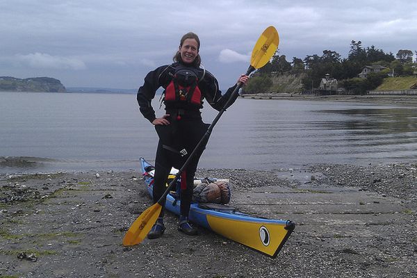 Nadia White posing with kayak