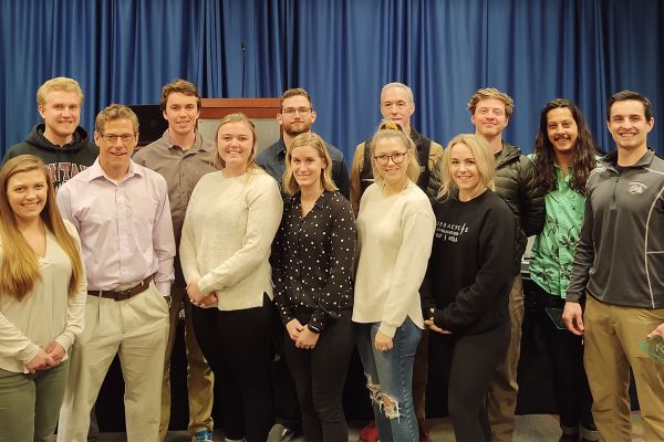 John Quindry posing with a group of students