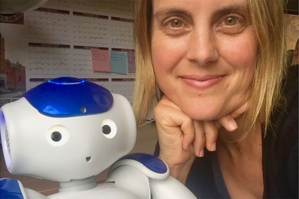 Rachel Severson posing with small kids robot