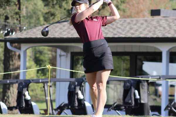 Teigan Avery hitting a golf ball with a driver