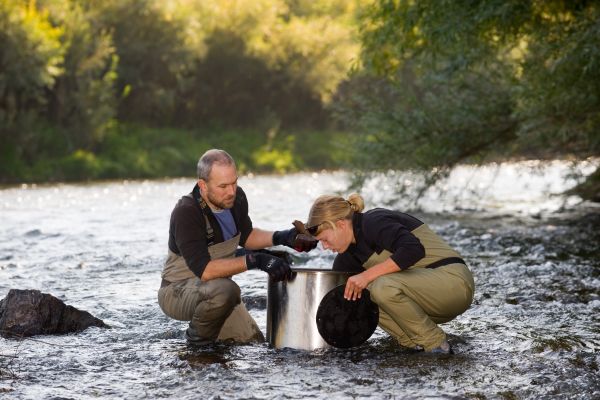 Researchers investigating the river with equipment