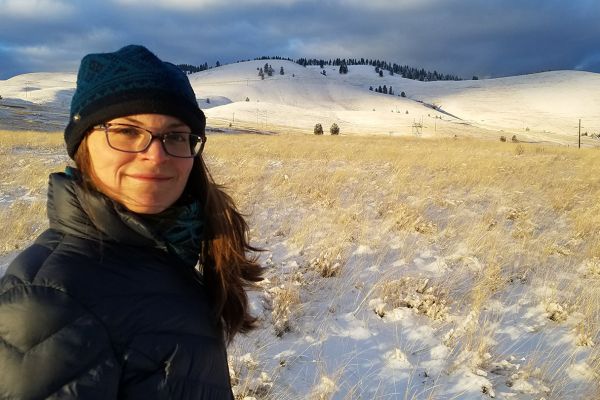 Rebekah Skoog posing in front of snowy hill