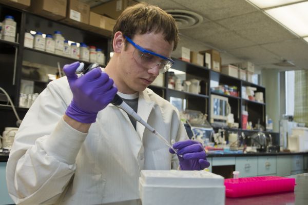 Chemistry student researching with scientific equipment