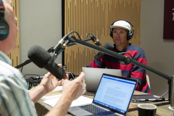 Justin Angle listening while recording a podcast