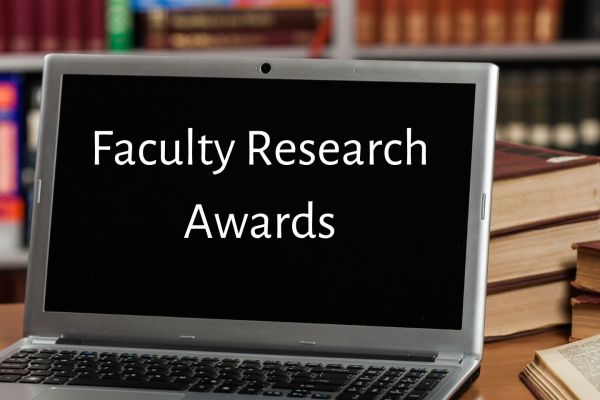 laptop with faculty research awards written on screen