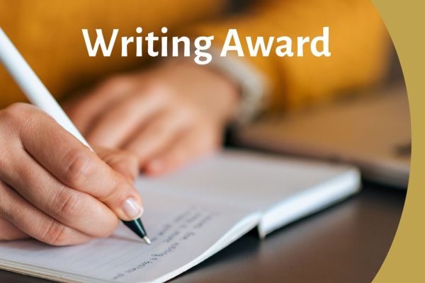hand writes on paper with pen