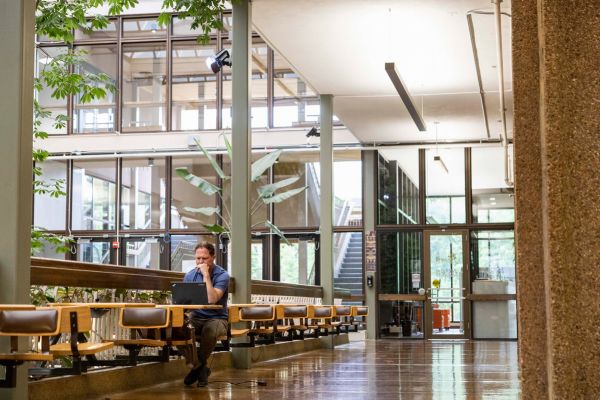 a man studies on the second floor of the UC.